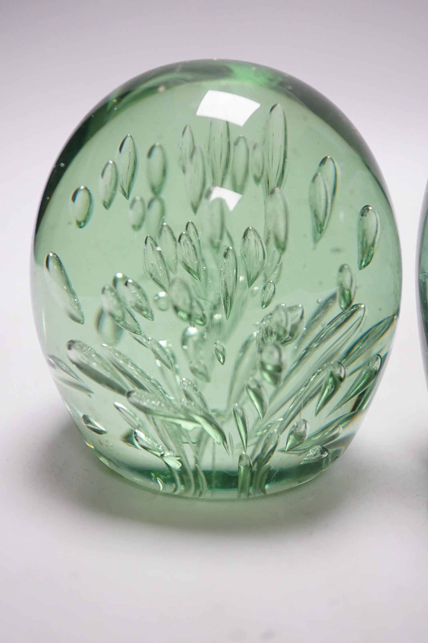 Four 19th century green glass dumps, one floral, tallest 16cms high